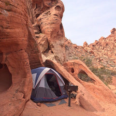 blue tent pitched in a canyon