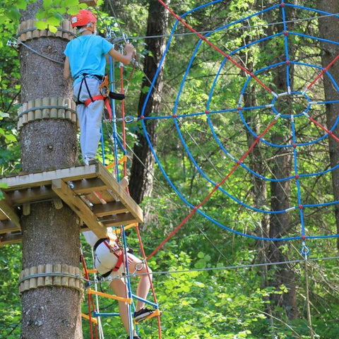 persons riding on the ropes and climibing on them