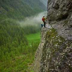 a person is hiking on the green mountain