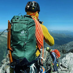 a person is wearing the black healment and green backpack
