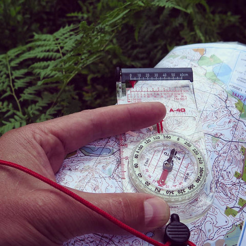 the person is checking the map with compass 