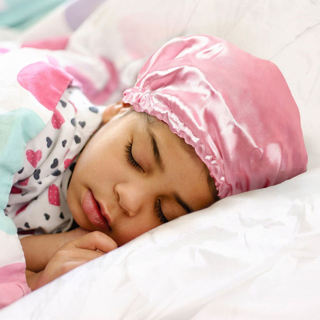 Child Wearing a Sleep Bonnet Or Silk Pillowcase at Night Time