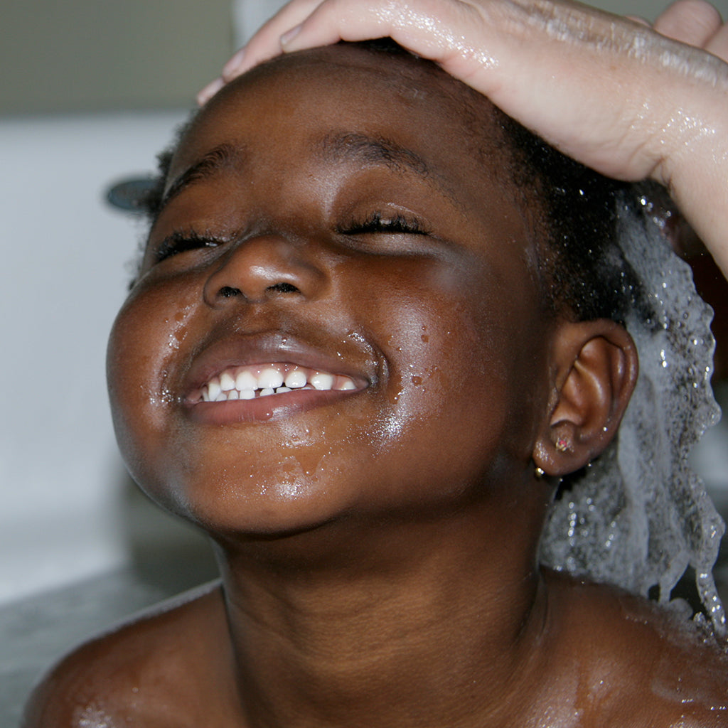 Washing little black girls hair