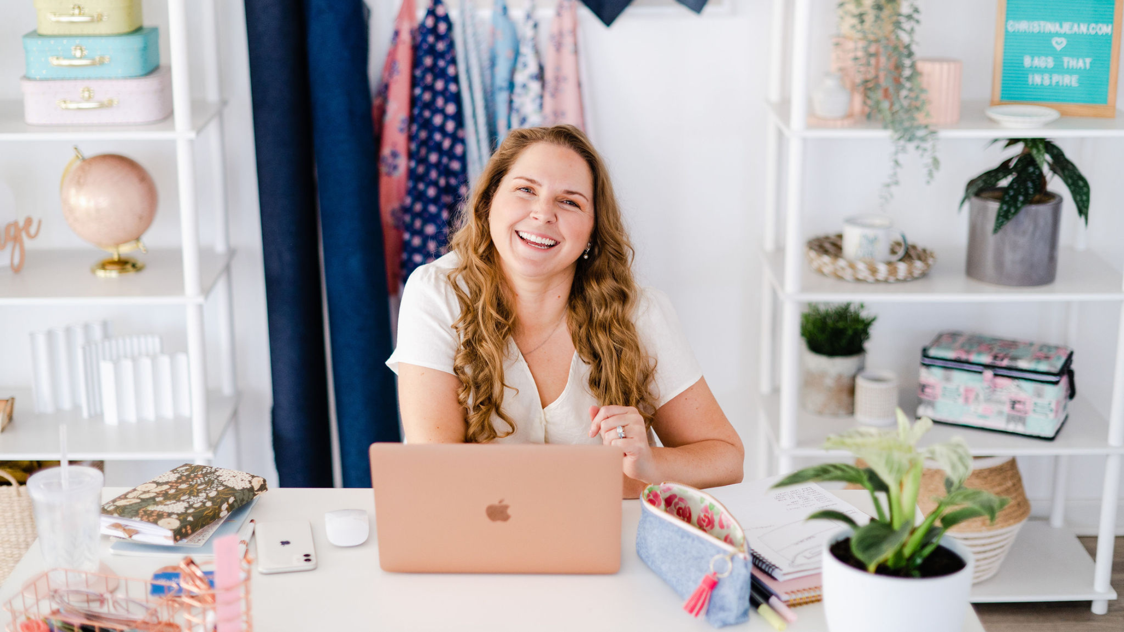 Christina Jean sitting at her desk working on new pattern designs and new purse designs