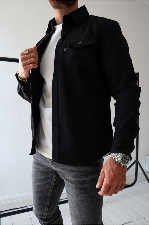 casual chic outfit inspiration : black denim, jean shirt + black puffer  vest - Lauren Schwaiger