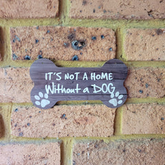 It is not a home without a dog  on brick wall