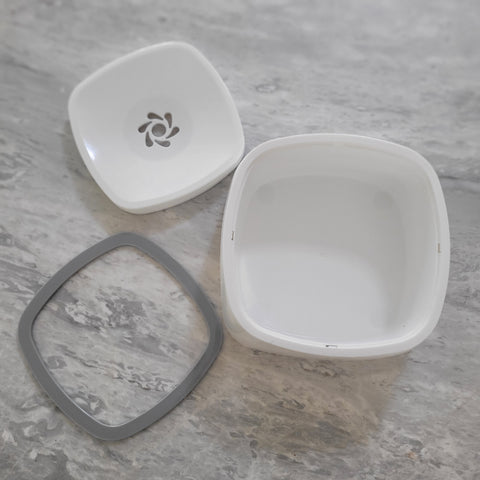 white non splash water bowl components ready for assembly. Bowl, floating plate and frame