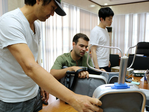 WAYB Pico Designer Kurtis Sakai, Head of Product Jeff Lockie, and materials lead Y.U. An, take over the CEO's office to review prototypes