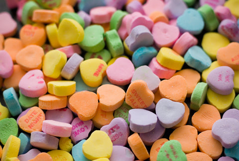 the image shows some love heart sweets