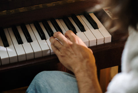 A picture of a left hand playing the piano