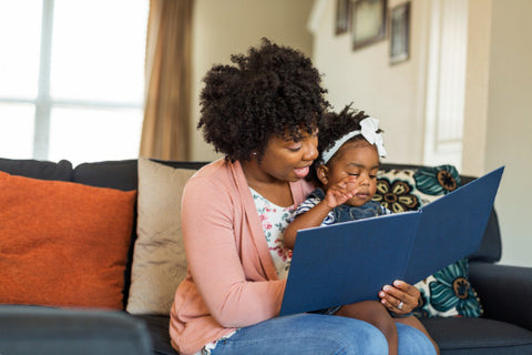 the image shows a mother and child reading a book