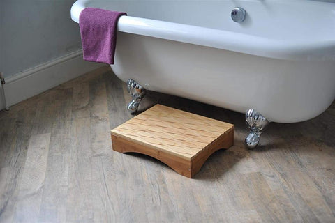the image shows a panda bamboo bathroom step next to a bath