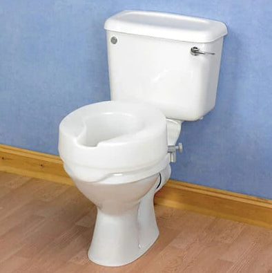 A toilet with a raised toilet seat in a bathroom