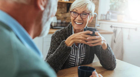 The image shows two people enjoying meeting up for a coffee