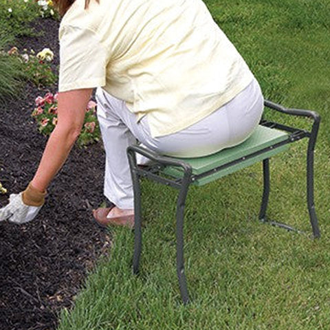 A woman sitting on the Folding Kneeler and Stool tending to a flower bed