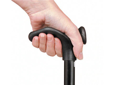 A hand gripping the handle of a walking stick