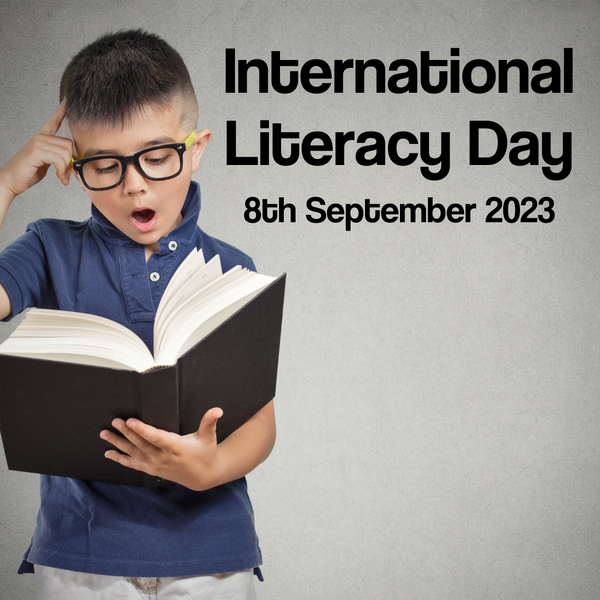 Text reads "International Literacy Day - 8th September 2023" next to child wearing glasses reading a book
