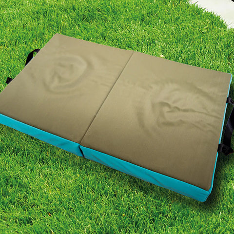 A picture of the Home and Garden Memory Foam Folding Kneeler Cushion, open, and on top of some grass