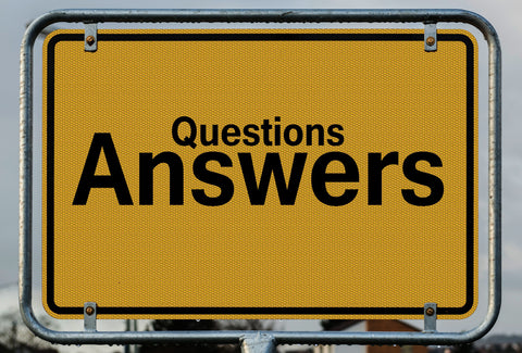 A sign with the words – questions answers – on it
