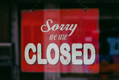 A – Sorry We Are Closed – sign, hanging in a window