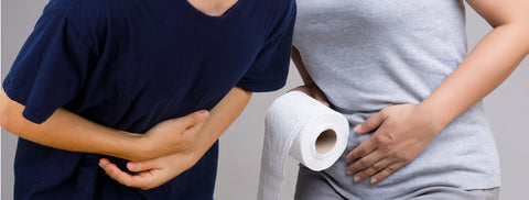 The torso of one man and one woman. They both have their hands on their stomachs, although in pain. The woman is holding a toilet roll