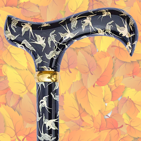 The head of the Swallows walking stick. The background is autumnal leaves and colours