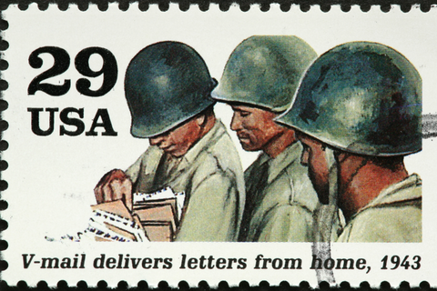 the image shows an american world war two stamp with soldiers getting letters