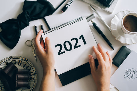 the image shows someone holding a 2021 calendar