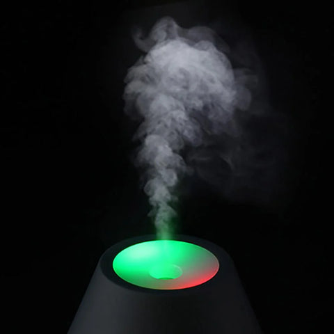 Lifemax Volcano diffuser misting a room with LED light display in red and green