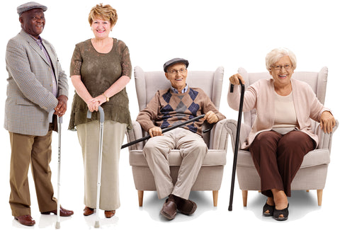 2 men and 2 women – all four are holding walking sticks. One man and one woman are sitting in armchairs