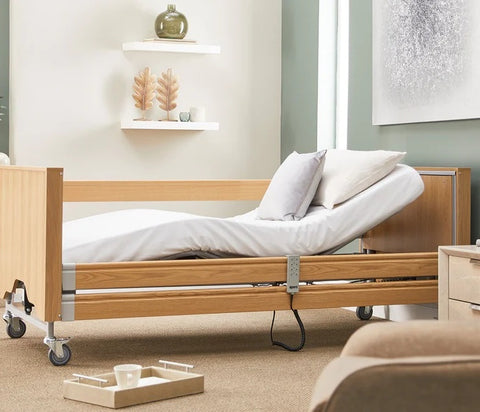 The Opera Classic profiling bed in the middle of a room. The remote control has been used to activate the mattress platform back rest.