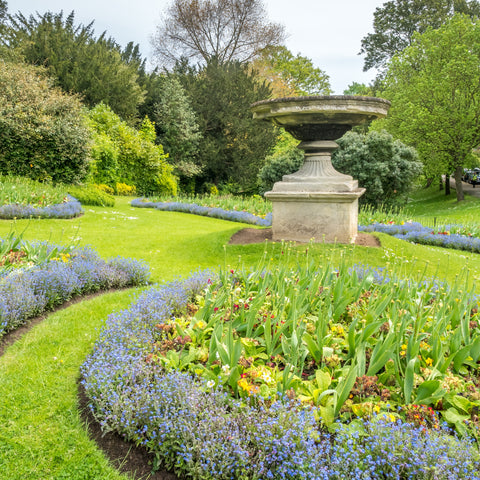 British garden with flowerbeds and ornament