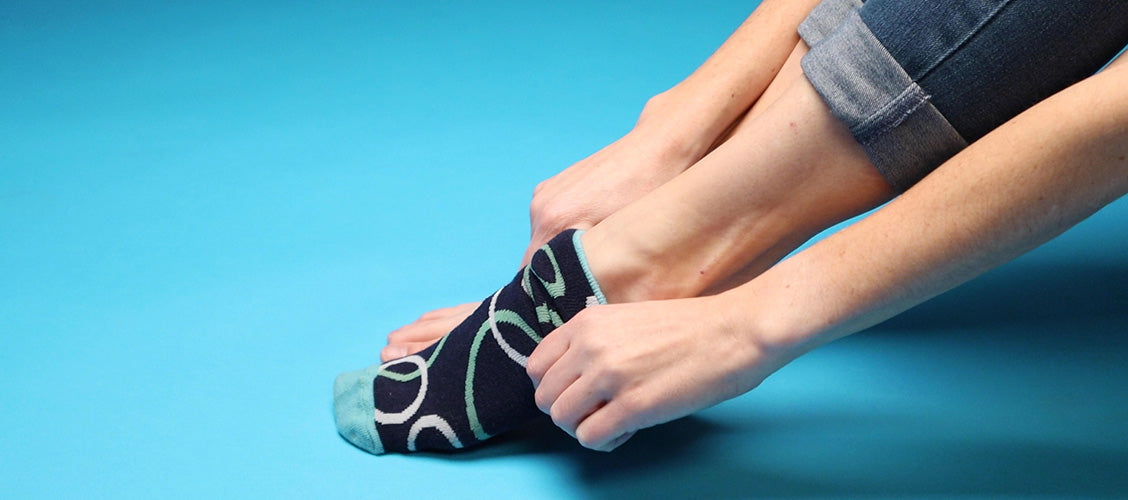 Woman putting her toes into bubble socks