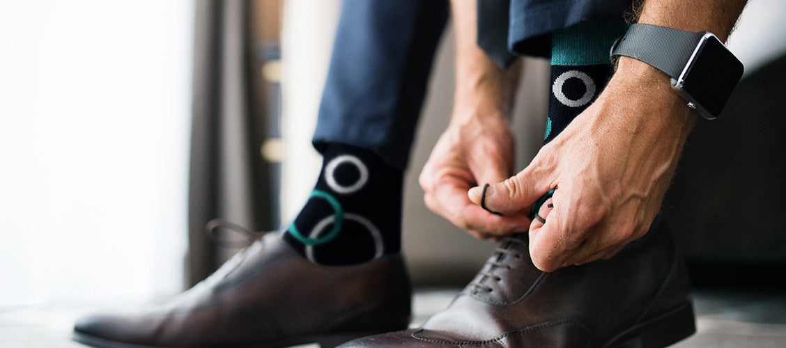 Man in suit tying shoes - How to Style Crew Socks