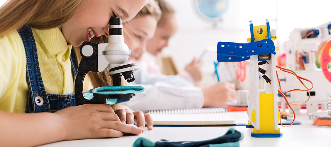 Girl looking at socks through microscope - Science of Socks