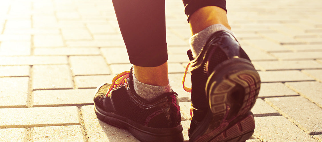 Woman walking wearing running shoes and low-cut socks - Types of Socks