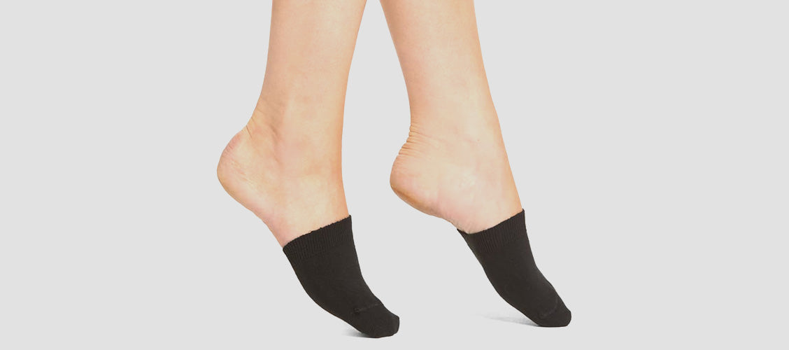 Woman standing on toes wearing black toe covers - 10 Unexpected Socks