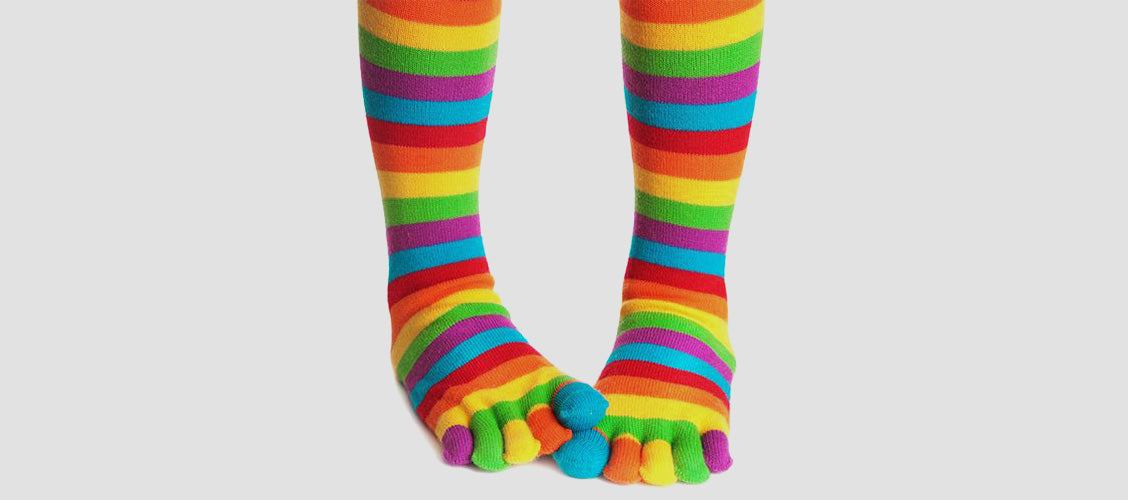 Woman wearing rainbow colored toe socks that go over the knee - 10 Unexpected Socks