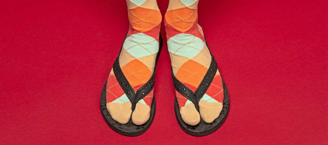 Woman wearing argyle split-toe socks with black flip flops - 10 unexpected socks