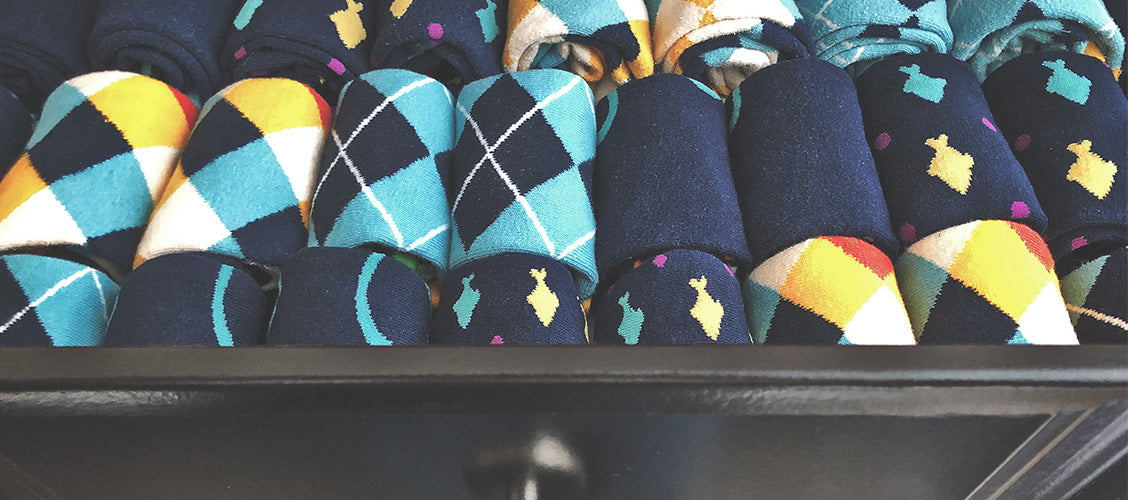Dresser drawer full of fun socks that are rolled up and placed side by side - 6 Ways to Fold Socks