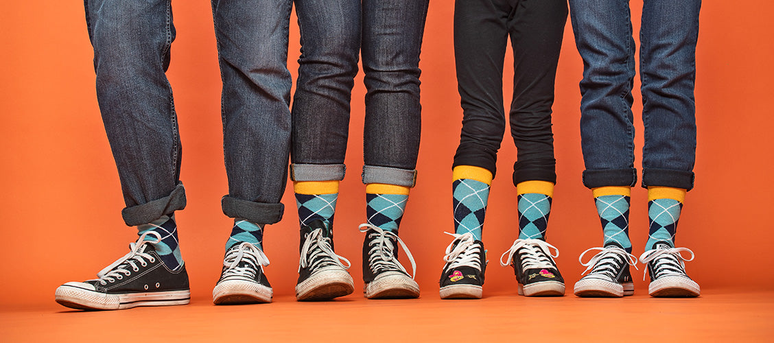 Four people standing next to each other wearing matching socks and shoes - Why Matching is Fun