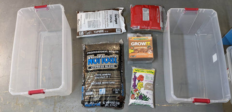 Two large tubs with bags of play sand, top soil, cypress mulch, coco fiber, and vermiculite.