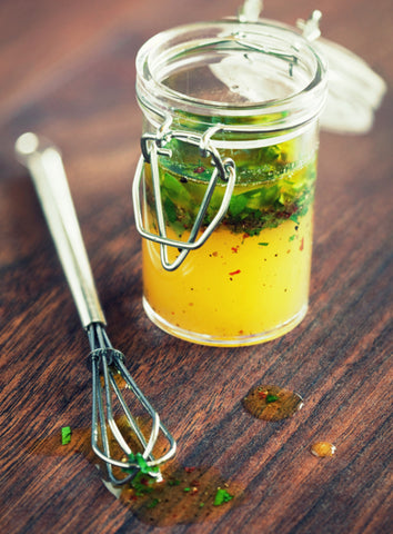 Salad dressing in a mason jar and a whisk