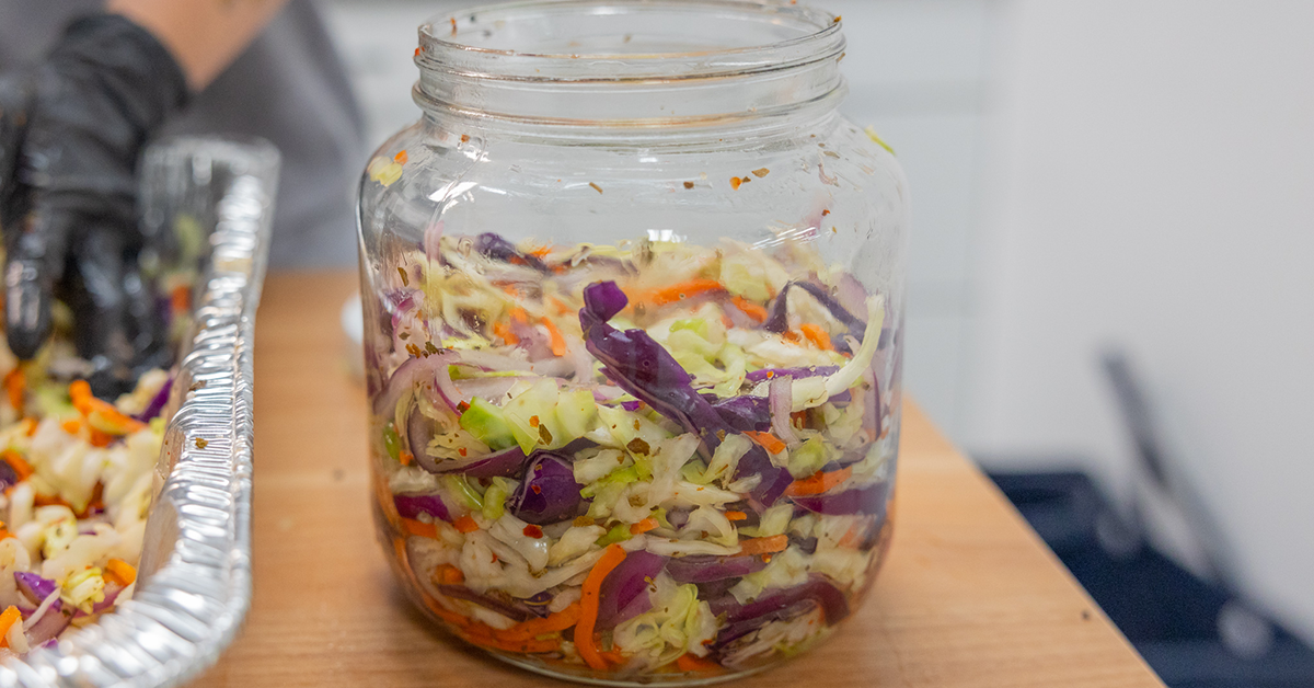 Packing curtido into fermentation jar