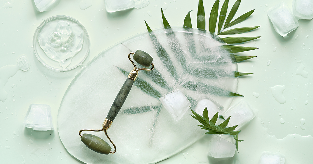 facial ice roller laying on a glass plate