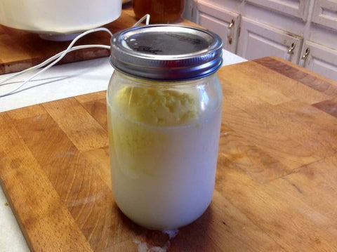 water, sourdough, and buttermilk mixed in a jar