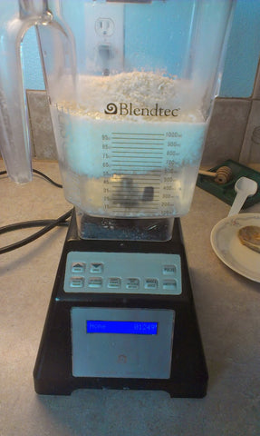 Shredded coconut and water in blender