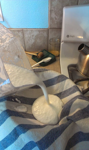 Pouring coconut and water mixture into a tight-weave towel 