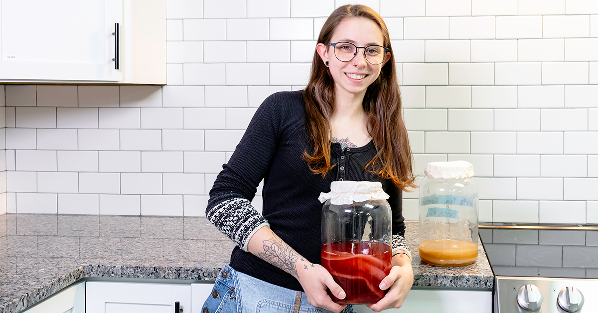 a girl named cara who is holding kombucha cultures and a scoby