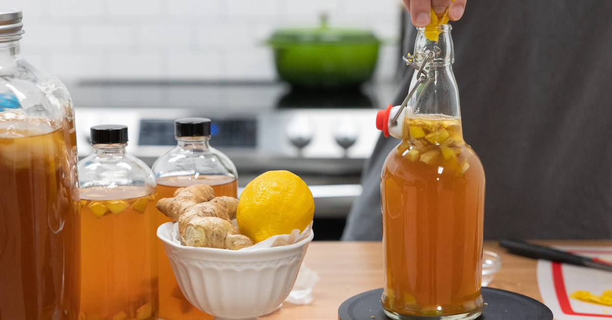 putting ginger into the bottle of lemon ginger kombucha